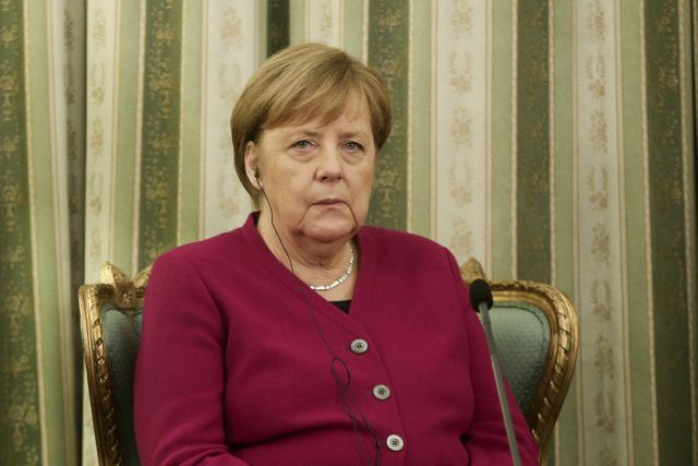 Merkel stresses German interest in Greek growth with business figures