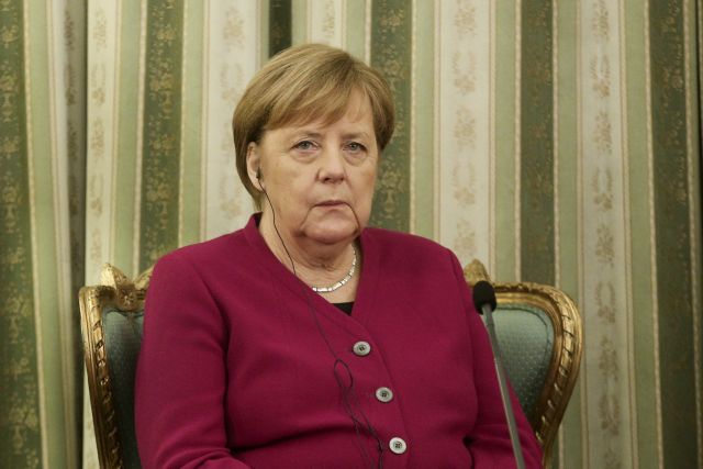 Merkel stresses German interest in Greek growth with business figures