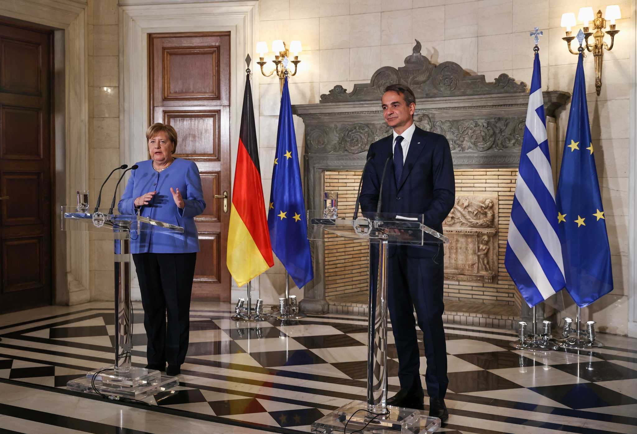 Merkel says she 'demanded much of the Greeks' but it was necessary to protect the common currency