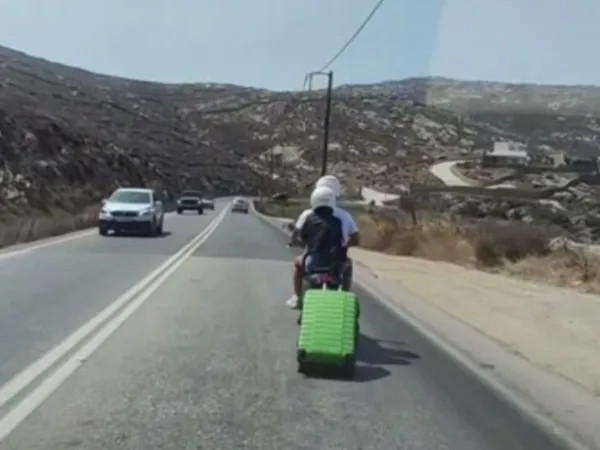 Μύκονος: Τουρίστες σέρνουν βαλίτσα με ροδάκια πίσω από μηχανάκι