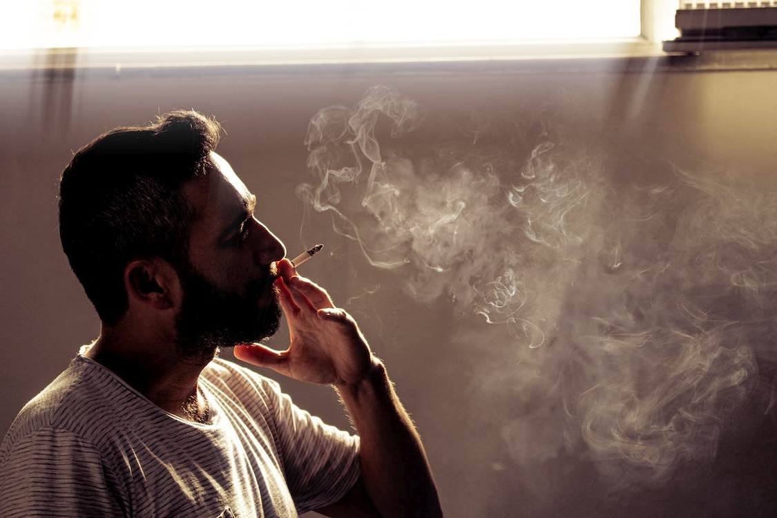 free photo of man smoking cigarette