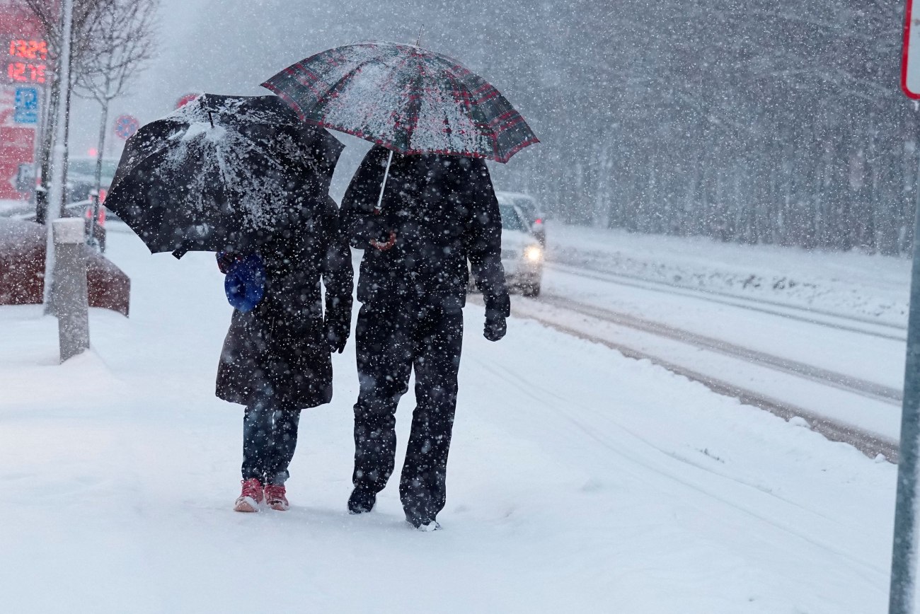 εικόνα που δείχνει κατοίκους του Άλμποργκ στη Δανία να περπατούν κατά τη διάρκεια ισχυρής χιονόπτωσης
