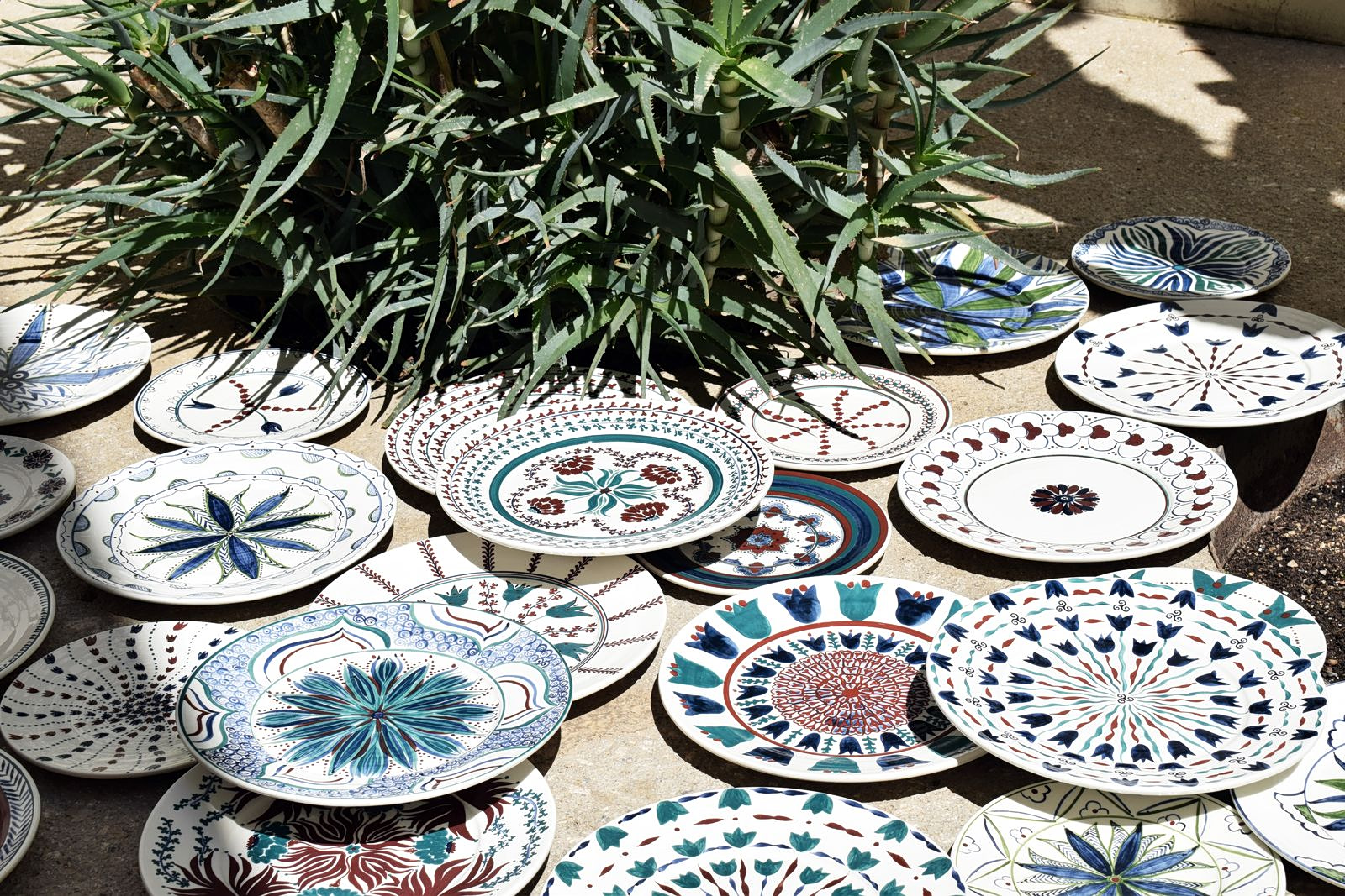 Atalanti Martinou, Quatrefoil, 2026, hand painted and glazed earthware clay, installation of 40 pieces of various dimensions.
